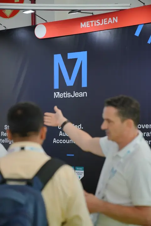 MetisJean at AI Everything Abu Dhabi: pointing a visitor to the MetisJean wall